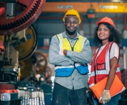istockphoto-1424854489-612x612 Portrait of professional happy smiling Black African American engineers, workers, technician man and woman wear hard hat, use clipboard discuss work in steel metal plant manufacturing factory industry